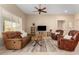 Cozy living room featuring a ceiling fan, plush seating, and a neutral-toned rug over tiled floor at 16390 W Sheila Ln, Goodyear, AZ 85395