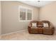 Cozy room with chair, shuttered window, and neutral walls, perfect for relaxation at 16390 W Sheila Ln, Goodyear, AZ 85395