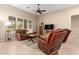 Living room showcasing comfortable furniture, a ceiling fan, and natural light through plantation shutters at 16390 W Sheila Ln, Goodyear, AZ 85395