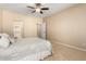 Bedroom featuring soft carpet, a ceiling fan, and access to an en-suite bathroom and walk-in closet at 16390 W Sheila Ln, Goodyear, AZ 85395