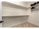 Spacious walk-in closet featuring built-in shelving and ample storage space at 16390 W Sheila Ln, Goodyear, AZ 85395