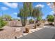 Backyard with desert landscaping, rock, cacti and privacy wall at 17661 N Saddle Ridge Dr, Surprise, AZ 85374