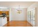 Elegant dining area with hardwood floors, a chandelier, and natural lighting at 17661 N Saddle Ridge Dr, Surprise, AZ 85374