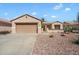 Charming single-story home featuring a desert-landscaped front yard and two-car garage at 17661 N Saddle Ridge Dr, Surprise, AZ 85374