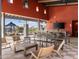 Outdoor lounge area with modern seating, a large flat-screen TV, and a view of the pool at 17714 W Amber Dr, Goodyear, AZ 85338