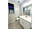 Modern bathroom featuring a white vanity, sleek fixtures, and a shower-tub combination at 17829 W Red Fox Rd, Surprise, AZ 85387