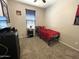 Cozy bedroom with a ceiling fan, carpeted floors, and a window dressed with horizontal blinds at 17829 W Red Fox Rd, Surprise, AZ 85387