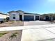 Charming single-story home featuring a three-car garage and well-manicured front yard at 17829 W Red Fox Rd, Surprise, AZ 85387