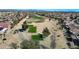 A scenic aerial view shows lush golf course fairways nestled within a neighborhood with beautifully landscaped homes at 18102 N Petrified Forest Dr, Surprise, AZ 85374