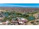 Aerial view of community featuring tennis courts, pools, a golf course, and a scenic pond with a fountain at 18102 N Petrified Forest Dr, Surprise, AZ 85374