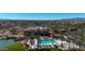 Aerial view of a community pool, desert landscaping, and mountains in the distance at 18102 N Petrified Forest Dr, Surprise, AZ 85374