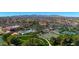 An aerial view of a community with a pool, tennis courts, green spaces and lush landscaping at 18102 N Petrified Forest Dr, Surprise, AZ 85374