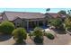 An aerial view of a desert home showcasing a backyard patio, landscaping, and a terracotta-tiled roof at 18102 N Petrified Forest Dr, Surprise, AZ 85374