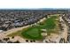 An aerial view showcases the lush green golf course and neighboring homes in this beautiful community at 18102 N Petrified Forest Dr, Surprise, AZ 85374