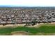 A panoramic aerial view reveals a residential neighborhood bordering a meticulously maintained green golf course at 18102 N Petrified Forest Dr, Surprise, AZ 85374