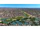 Aerial shot of an active adult community featuring tennis courts, a golf course, and a lake at 18102 N Petrified Forest Dr, Surprise, AZ 85374