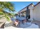 Covered back patio with an outdoor dining set and surrounding desert landscaping at 18102 N Petrified Forest Dr, Surprise, AZ 85374