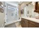 Bathroom showcasing a glass shower with white subway tile, white vanity with wood cabinets, and neutral paint at 18102 N Petrified Forest Dr, Surprise, AZ 85374