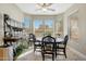 Dining area with a ceiling fan, ample natural light, and a stylish wine storage unit at 18102 N Petrified Forest Dr, Surprise, AZ 85374