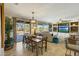 Bright dining area with patio access, a pendant light, and an open view into the living room at 18102 N Petrified Forest Dr, Surprise, AZ 85374