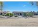 Back of home with desert landscaping, covered patio, and tile roof at 18102 N Petrified Forest Dr, Surprise, AZ 85374