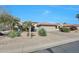 Charming single-story home featuring desert landscaping, a red tile roof and neutral color palette at 18102 N Petrified Forest Dr, Surprise, AZ 85374