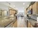 Well-lit kitchen with stainless steel appliances, granite countertops, and views into the dining area at 18102 N Petrified Forest Dr, Surprise, AZ 85374