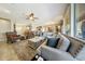 Inviting living room featuring a large sofa, neutral tones, and an open floor plan at 18102 N Petrified Forest Dr, Surprise, AZ 85374