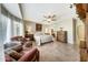 The neutral-painted main bedroom offers tile flooring, natural light, and a ceiling fan at 18102 N Petrified Forest Dr, Surprise, AZ 85374