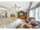 Comfortable main bedroom showcases two chairs, a ceiling fan, and a view of the outside at 18102 N Petrified Forest Dr, Surprise, AZ 85374