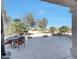 Relaxing outdoor patio featuring desert landscaping, a table and chairs, and views of the lush green golf course at 18102 N Petrified Forest Dr, Surprise, AZ 85374