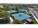 Overhead shot of community tennis courts and parking lot surrounded by mature trees and lush landscaping at 18102 N Petrified Forest Dr, Surprise, AZ 85374