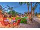 Lovely backyard features a pool and outdoor dining area with lush landscaping at 188 E Mountain View Rd, San Tan Valley, AZ 85143