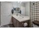 Bathroom featuring a double sink vanity, plaid wallpaper, and wood-look flooring at 188 E Mountain View Rd, San Tan Valley, AZ 85143