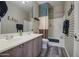 Bathroom featuring a double sink vanity, plaid wallpaper, and shower-tub combination at 188 E Mountain View Rd, San Tan Valley, AZ 85143