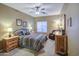 Comfortable bedroom with Southwestern-style bedding, ceiling fan, and wooden nightstands at 188 E Mountain View Rd, San Tan Valley, AZ 85143