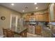 Well-lit kitchen featuring wood cabinets, stainless steel appliances, granite countertops, and backsplash at 188 E Mountain View Rd, San Tan Valley, AZ 85143