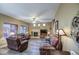 Spacious living room with fireplace, wood flooring, ceiling fan and neutral paint at 188 E Mountain View Rd, San Tan Valley, AZ 85143