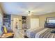 Spacious main bedroom features a ceiling fan, TV, built-in shelving, and ensuite bath at 188 E Mountain View Rd, San Tan Valley, AZ 85143