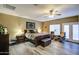 Large main bedroom featuring ceiling fan, wood floors and french doors to the back at 188 E Mountain View Rd, San Tan Valley, AZ 85143