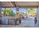 Covered patio area featuring outdoor kitchen and entertaining space with view of the pool at 188 E Mountain View Rd, San Tan Valley, AZ 85143