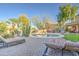 Beautiful backyard with a sparkling pool, sun loungers, lush landscaping, and desert plants at 188 E Mountain View Rd, San Tan Valley, AZ 85143