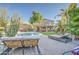 Backyard oasis with a refreshing pool, palm trees, lush greenery, and chaise lounges at 188 E Mountain View Rd, San Tan Valley, AZ 85143