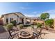 Backyard featuring a charming fire pit surrounded by seating, lush foliage, and ample space for gatherings at 20551 N 262Nd Ave, Buckeye, AZ 85396