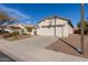 Charming single-story home featuring a two-car garage, desert landscaping, and neutral stucco exterior at 20551 N 262Nd Ave, Buckeye, AZ 85396