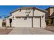 Garage of home featuring windows, exterior lights, and desert landscaping in front at 20551 N 262Nd Ave, Buckeye, AZ 85396