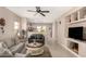 Open-concept living room seamlessly connects to the kitchen, perfect for gatherings, with neutral decor and a ceiling fan at 20551 N 262Nd Ave, Buckeye, AZ 85396