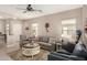 Inviting living room filled with natural light, neutral paint, cozy seating and a ceiling fan for added comfort at 20551 N 262Nd Ave, Buckeye, AZ 85396