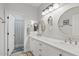 Bright bathroom with double sinks, white cabinets and neutral countertops at 21921 E Domingo Rd, Queen Creek, AZ 85142