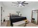 Comfortable bedroom with ceiling fan, window shutters and minimalist decor at 21921 E Domingo Rd, Queen Creek, AZ 85142